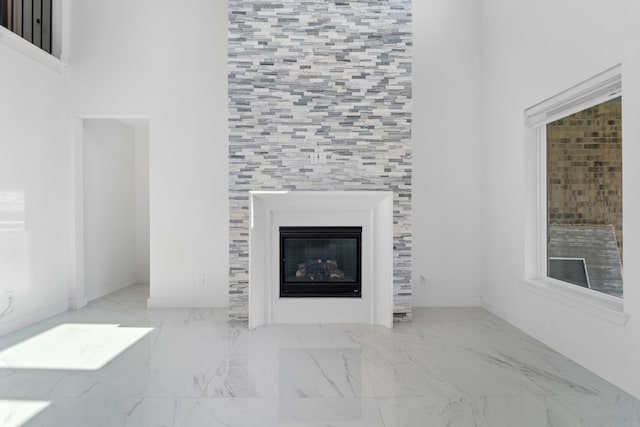 9818 Daffodil Springs Dr, Richmond, TX 77407 - unfurnished living room with marble finish flooring, a tile fireplace, and baseboards