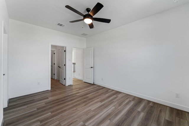 9818 Daffodil Springs Dr, Richmond, TX 77407 - unfurnished bedroom with wood finished floors, baseboards, and ceiling fan