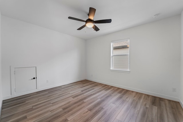 9818 Daffodil Springs Dr, Richmond, TX 77407 - empty room with wood finished floors, a ceiling fan, and baseboards