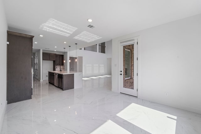 9818 Daffodil Springs Dr, Richmond, TX 77407 - unfurnished living room featuring light marble finish flooring and recessed lighting