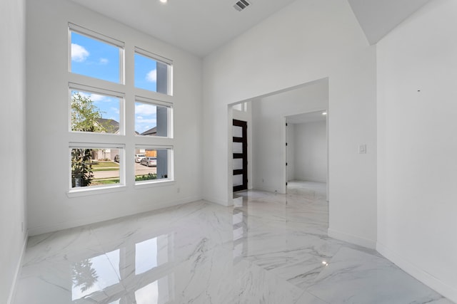 9818 Daffodil Springs Dr, Richmond, TX 77407 - unfurnished room with marble tiled flooring, baseboards, and a towering ceiling