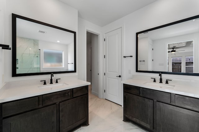 9818 Daffodil Springs Dr, Richmond, TX 77407 - full bathroom featuring marble look tiles, a marble finish shower, two vanities, and a ceiling fan