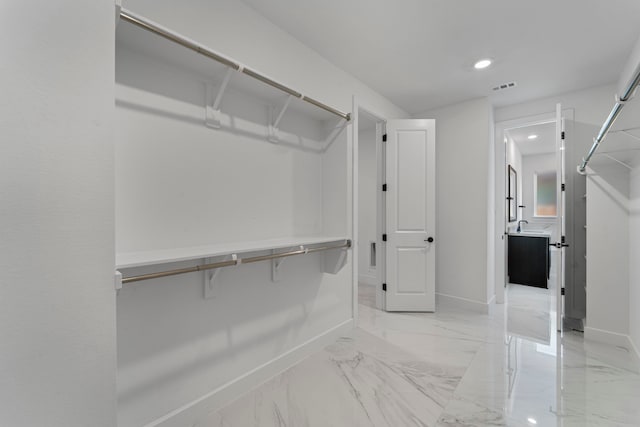 9818 Daffodil Springs Dr, Richmond, TX 77407 - spacious closet featuring light marble finish floors and a sink