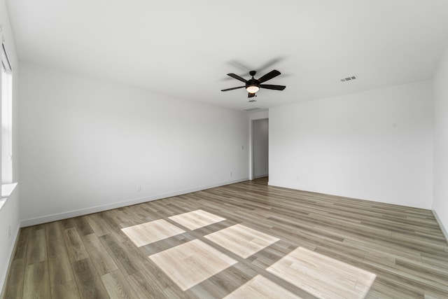 9818 Daffodil Springs Dr, Richmond, TX 77407 - spare room featuring ceiling fan, light wood-type flooring, and baseboards