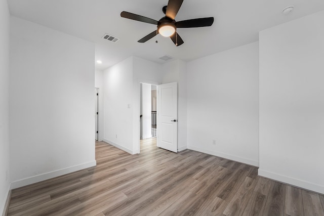 9818 Daffodil Springs Dr, Richmond, TX 77407 - spare room with a ceiling fan, wood finished floors, baseboards, recessed lighting, and a smoke detector