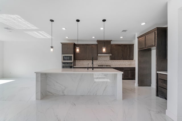 9818 Daffodil Springs Dr, Richmond, TX 77407 - kitchen with appliances with stainless steel finishes, decorative backsplash, light marble finish floors, dark brown cabinets, and hanging light fixtures