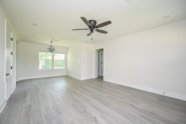 226 Hyta St, Houston, TX 77018 - unfurnished room featuring wood finished floors, a ceiling fan, a chandelier, and baseboards