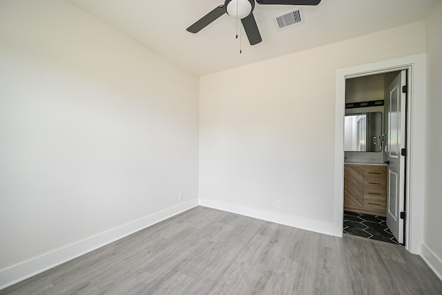 226 Hyta St, Houston, TX 77018 - unfurnished bedroom featuring wood finished floors, baseboards, ceiling fan, and ensuite bath