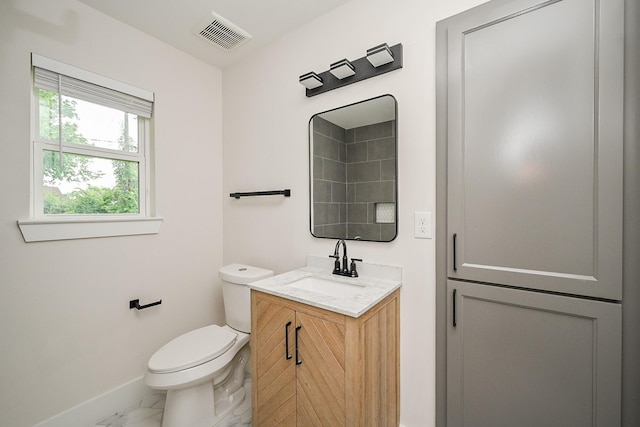 226 Hyta St, Houston, TX 77018 - bathroom with baseboards, marble finish flooring, vanity, and toilet