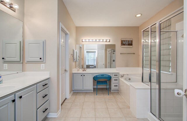 18611 Camellia Estates Ln, Cypress, TX 77429 - full bathroom with two vanities, a stall shower, a bath, tile patterned floors, and recessed lighting