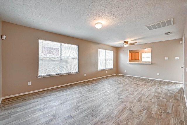 1406 Hade Falls Ln, Houston, TX 77073 - unfurnished room featuring light wood-style floors, ceiling fan, a textured ceiling, and baseboards