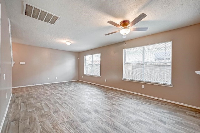 1406 Hade Falls Ln, Houston, TX 77073 - unfurnished room with a textured ceiling, a ceiling fan, wood finished floors, and baseboards
