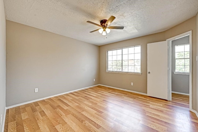 1406 Hade Falls Ln, Houston, TX 77073 - unfurnished room with a ceiling fan, light wood finished floors, a textured ceiling, and baseboards