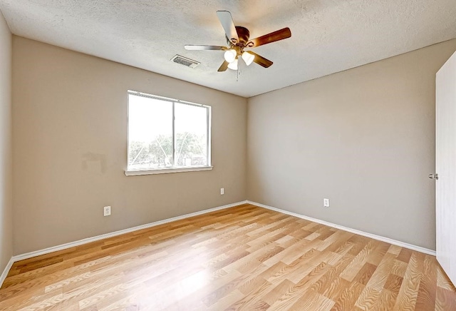 1406 Hade Falls Ln, Houston, TX 77073 - empty room with a ceiling fan, light wood-style floors, baseboards, and a textured ceiling