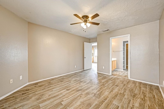 1406 Hade Falls Ln, Houston, TX 77073 - unfurnished bedroom with light wood-type flooring, baseboards, a ceiling fan, and ensuite bathroom