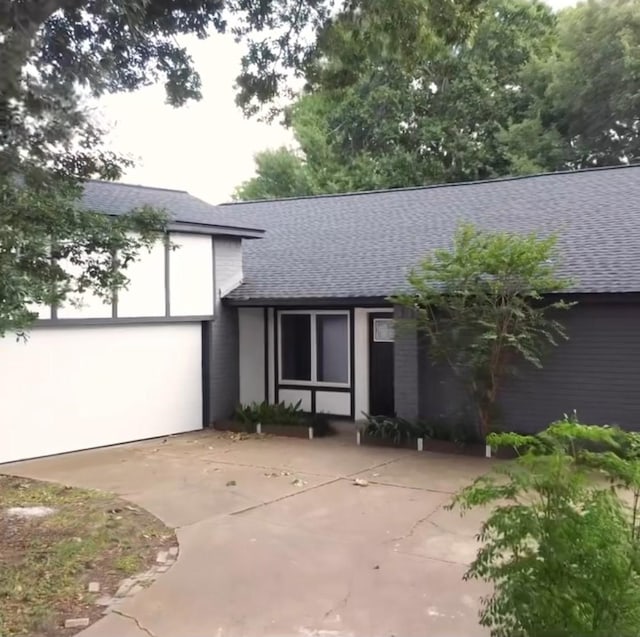 16026 Beechnut St, Houston, TX 77083 - view of front of home with a shingled roof and concrete driveway