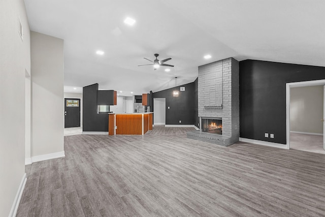 16026 Beechnut St, Houston, TX 77083 - unfurnished living room featuring a ceiling fan, lofted ceiling, light wood-type flooring, a fireplace, and recessed lighting