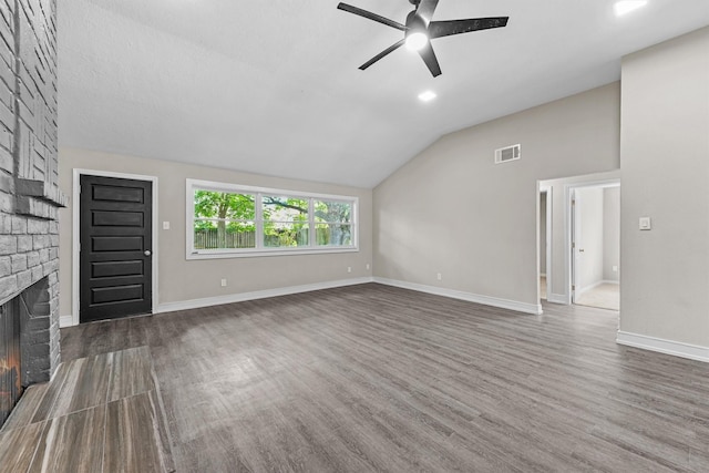 16026 Beechnut St, Houston, TX 77083 - unfurnished living room featuring a ceiling fan, a fireplace, dark wood finished floors, and lofted ceiling