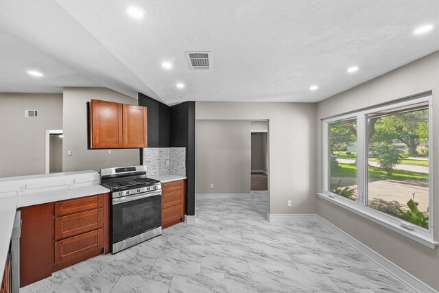 16026 Beechnut St, Houston, TX 77083 - kitchen with stainless steel range with gas cooktop, light marble finish flooring, recessed lighting, light countertops, and backsplash