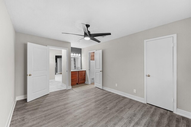 16026 Beechnut St, Houston, TX 77083 - unfurnished bedroom featuring light wood-type flooring, ensuite bathroom, and a ceiling fan