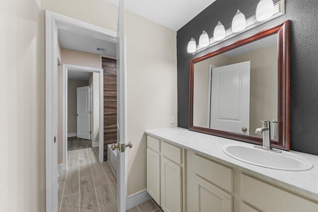 16026 Beechnut St, Houston, TX 77083 - bathroom with vanity and wood tiled floors