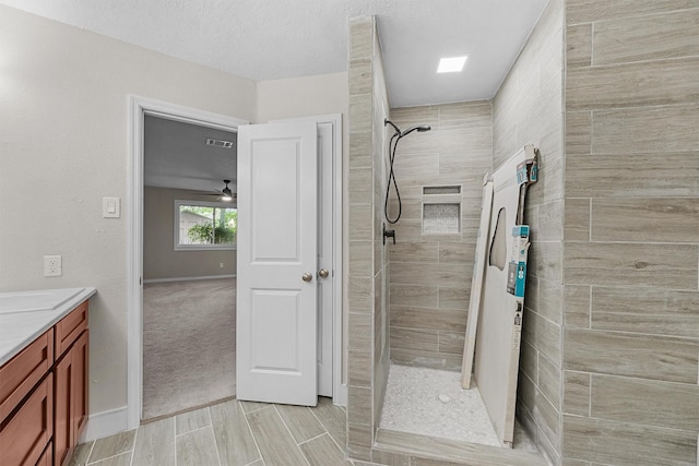 16026 Beechnut St, Houston, TX 77083 - bathroom with a tile shower, vanity, and a ceiling fan