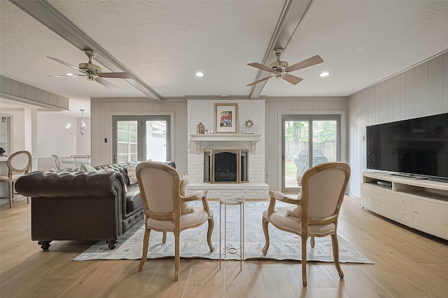 13622 Indian Creek Rd, Houston, TX 77079 - living room featuring ceiling fan, light wood-style floors, recessed lighting, a textured ceiling, and a brick fireplace