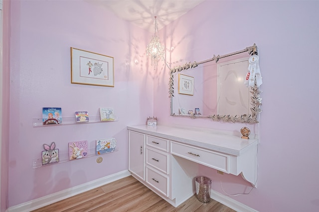 13622 Indian Creek Rd, Houston, TX 77079 - bathroom featuring wood finished floors, baseboards, and a chandelier