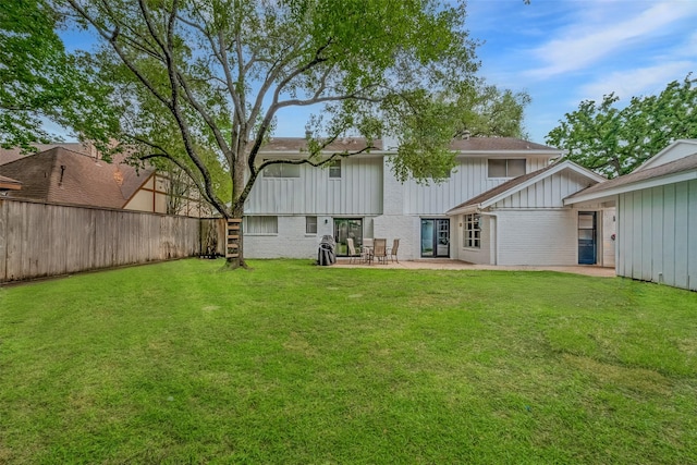 13622 Indian Creek Rd, Houston, TX 77079 - back of house with brick siding, board and batten siding, and a patio area