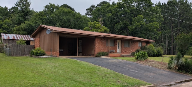 405 Gifford, Rusk, TX 75785 - ranch-style house with brick siding, asphalt driveway, an attached carport, and a view of trees