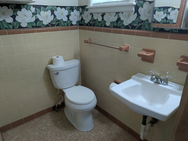 405 Gifford, Rusk, TX 75785 - half bathroom with toilet, tile walls, tile patterned floors, and a sink