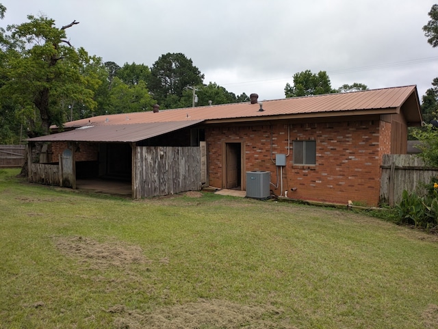 405 Gifford, Rusk, TX 75785 - back of property with central AC unit, metal roof, and brick siding