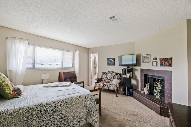 2893 Panagard Dr Unit 42, Houston, TX 77082 - bedroom with carpet floors, a textured ceiling, and a tile fireplace