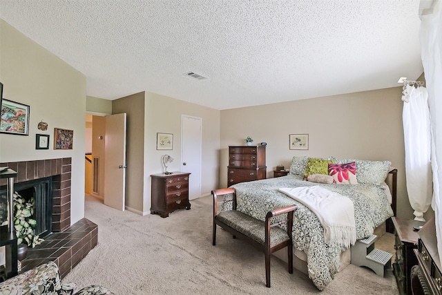2893 Panagard Dr Unit 42, Houston, TX 77082 - bedroom featuring light carpet, a textured ceiling, and a tile fireplace