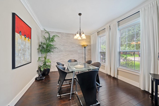 6218 Southcott Ct, Katy, TX 77450 - dining area featuring baseboards, a chandelier, crown molding, dark wood-style floors, and an accent wall