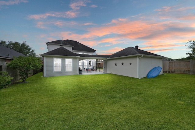 6218 Southcott Ct, Katy, TX 77450 - back of property at dusk with a patio