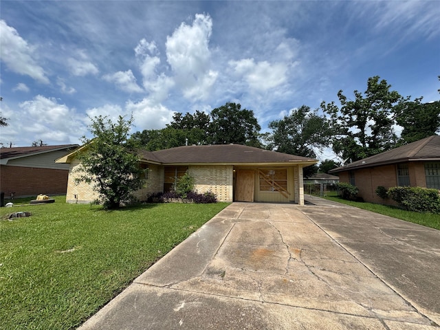 10509 Kelburn Dr, Houston, TX 77016 - view of front of house featuring concrete driveway, a front lawn, and brick siding