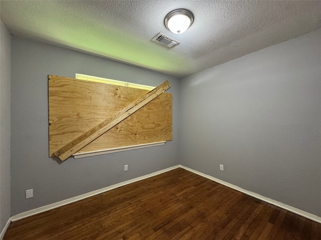 10509 Kelburn Dr, Houston, TX 77016 - spare room with wood finished floors, baseboards, and a textured ceiling