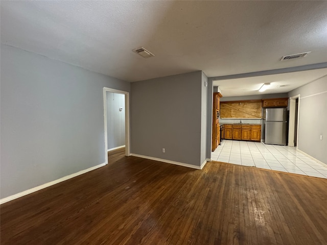 10509 Kelburn Dr, Houston, TX 77016 - unfurnished living room featuring baseboards and light wood-style flooring