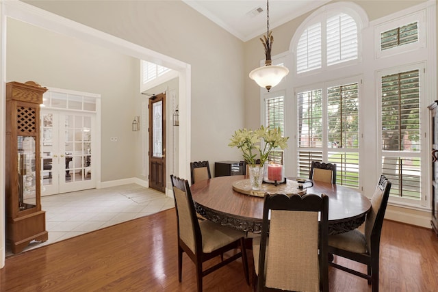 17814 Shady Arbor Way, Spring, TX 77379 - dining room with a towering ceiling, wood finished floors, french doors, ornamental molding, and baseboards