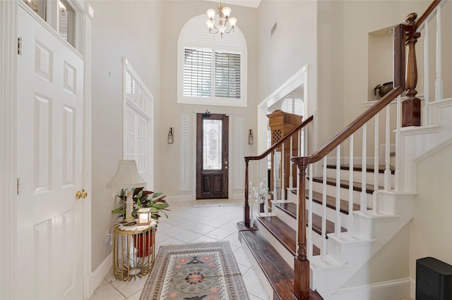 17814 Shady Arbor Way, Spring, TX 77379 - foyer entrance featuring a high ceiling, a chandelier, stairway, tile patterned flooring, and baseboards