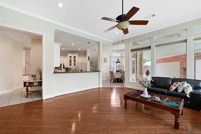 17814 Shady Arbor Way, Spring, TX 77379 - living room featuring light wood-type flooring, a ceiling fan, crown molding, baseboards, and recessed lighting