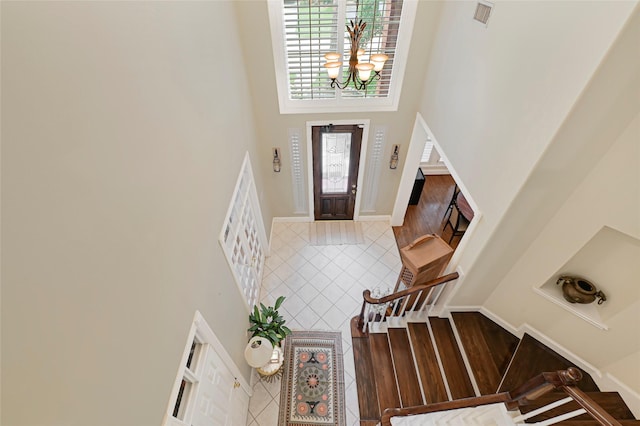 17814 Shady Arbor Way, Spring, TX 77379 - foyer entrance with a high ceiling, a chandelier, tile patterned flooring, and stairs