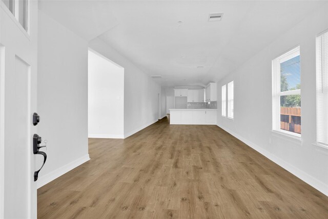 0 Basswood St, Houston, TX 77022 - unfurnished living room featuring light wood-style floors and baseboards