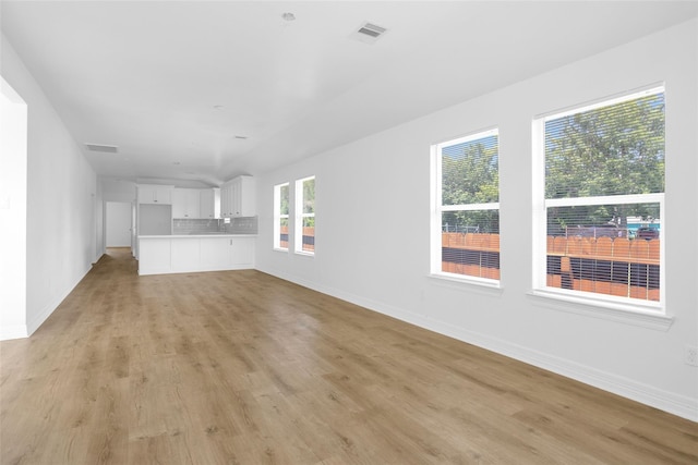 0 Basswood St, Houston, TX 77022 - unfurnished living room featuring light wood-style floors and baseboards