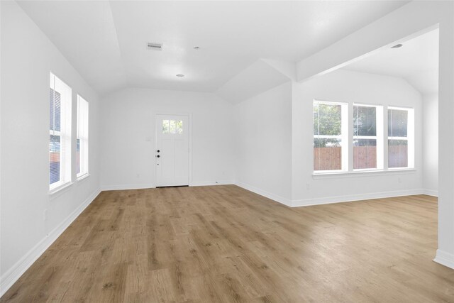 0 Basswood St, Houston, TX 77022 - entrance foyer featuring lofted ceiling, light wood-style flooring, healthy amount of natural light, and baseboards