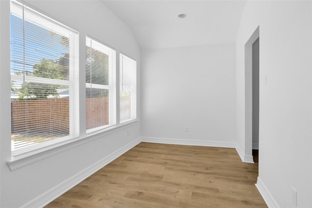 0 Basswood St, Houston, TX 77022 - spare room featuring plenty of natural light, light wood finished floors, vaulted ceiling, and baseboards
