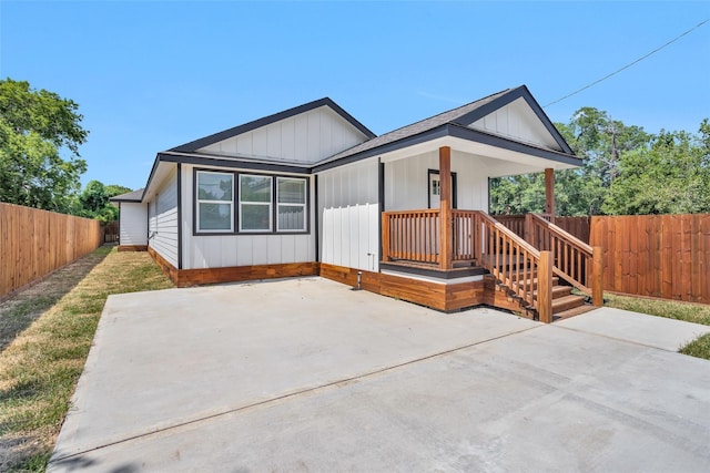 0 Basswood St, Houston, TX 77022 - view of front of house featuring a fenced backyard, a patio area, and board and batten siding