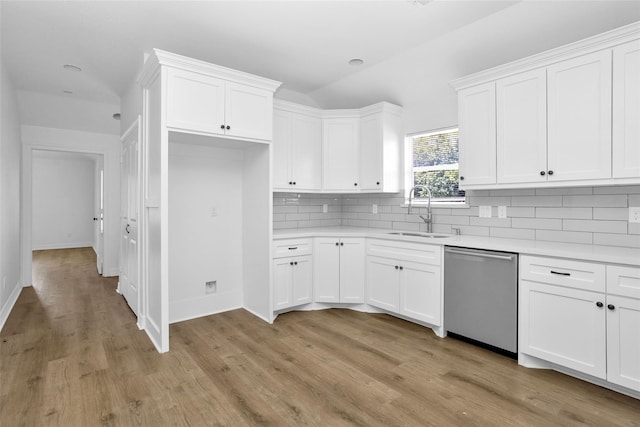 0 Basswood St, Houston, TX 77022 - kitchen featuring dishwasher, a sink, backsplash, light countertops, and white cabinetry
