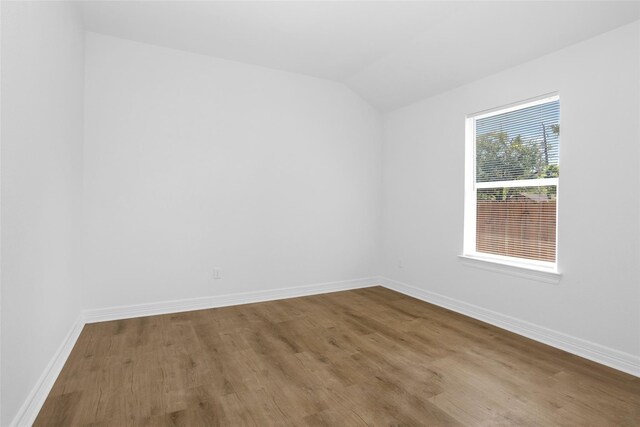 0 Basswood St, Houston, TX 77022 - spare room with wood finished floors, vaulted ceiling, and baseboards